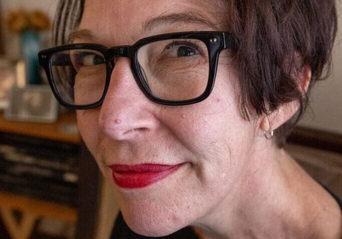 Woman with glasses and red lipstick